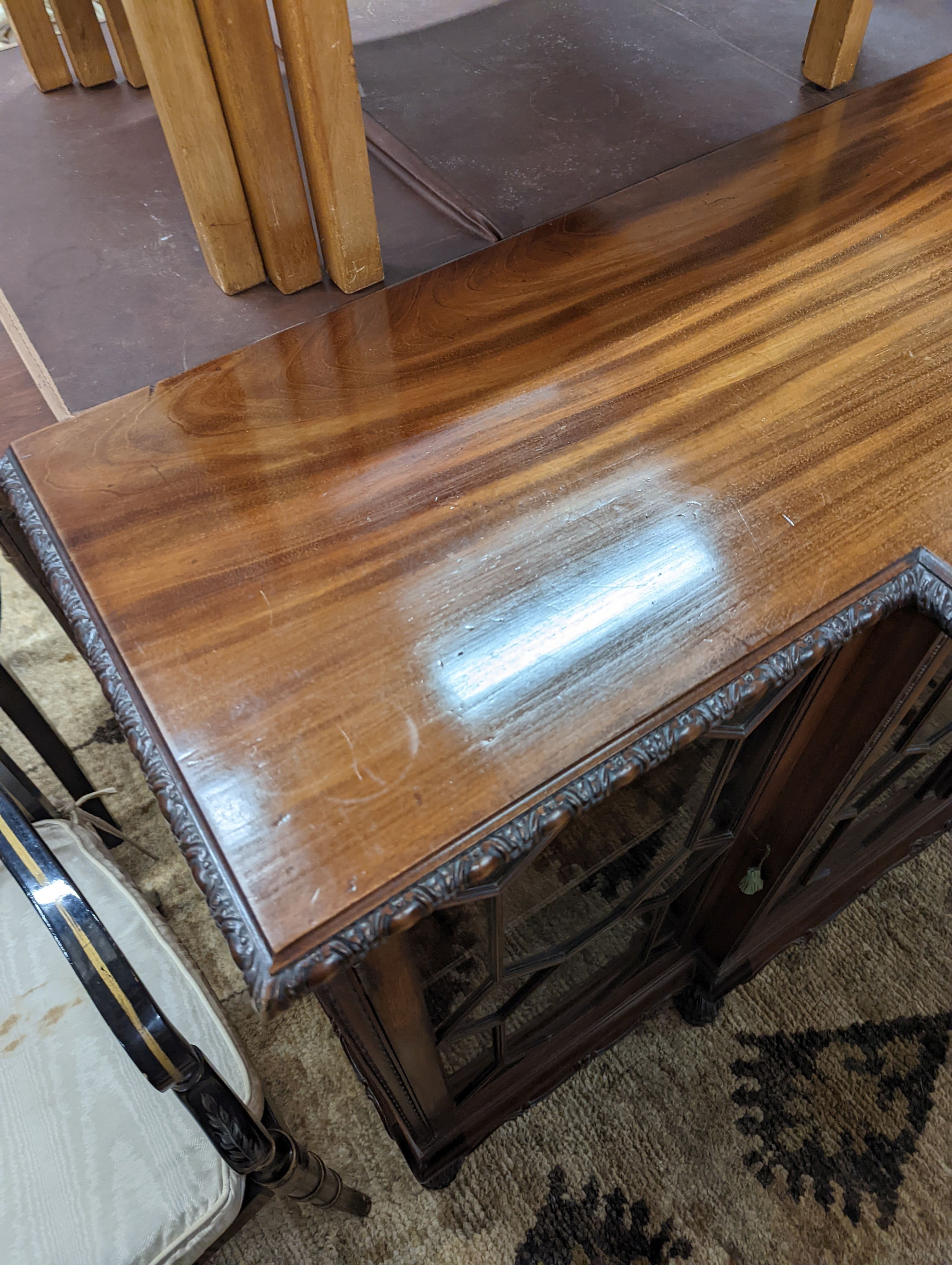 A 1920's Chippendale revival glazed mahogany break front dwarf cabinet, width 160cm, depth 43m, height 88cm